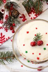 Homemade White Christmas cake with frosting on festive holiday background