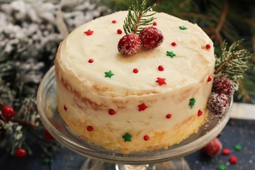 Homemade White Christmas cake with frosting on festive holiday background