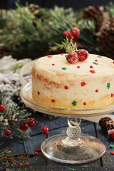 Homemade White Christmas cake with frosting on festive holiday background