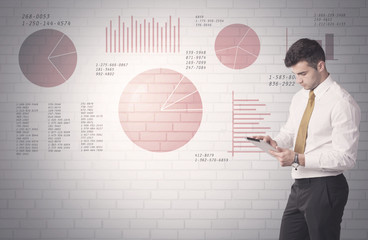 Pie charts and numbers on wall with salesman