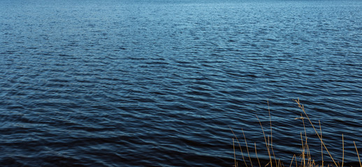 A close up of ripples on a blue lake