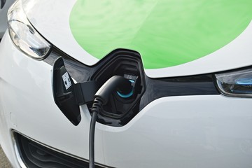 Close up power supply connected to electric car