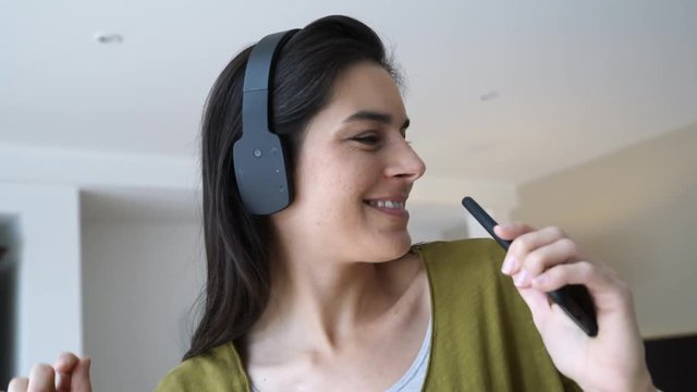 Woman listening to music with bluetooth headset