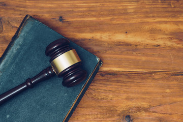 Gavel and law book on a wooden background