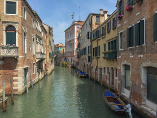 perspective of one of the canals of Venice, with its typical houses and boats