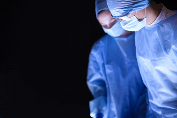 Team surgeon at work in operating room.