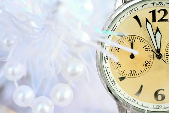 Image of New years eve celebration with clock with plastic pearls in background no people stock photo	