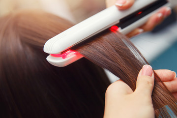 Keratin recovery hair and protein treatment pile with professional ultrasonic iron tool. Concept...