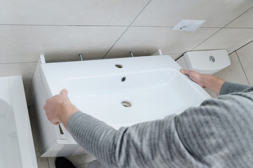 Installation the washbasin in the bathroom.