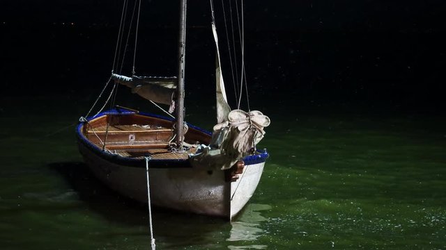 Boat drifting near the pier at night
