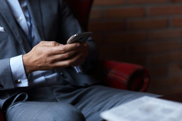 Young businessman texting on a smartphone