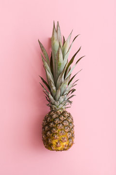 Top view on fresh organic pineapple on light pink background. Healthy food.