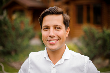 Portrait of handsome smiling man in white shirt