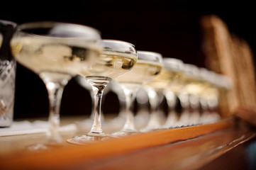 Set of elegant glasses with champagne arranged in line