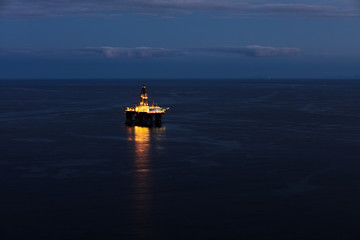 Offshore oil drilling rig on the south cost of Tenerife island on the North Atlantic Ocean. The sun has set revealing a beautiful light show © Bartkowski