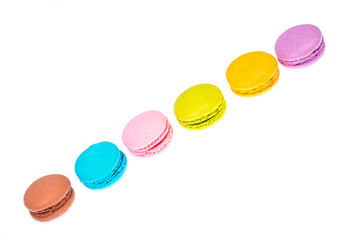 Delicate delightful delicious colored macaroons on white background