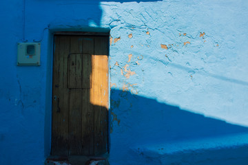 Door. Old wooden door. Juzcar village, Malaga province. Costa del Sol, Andalusia, Spain.