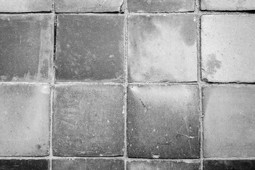 Close-up of a dusty and smooth paving viewed from above in black and white with vignetting.