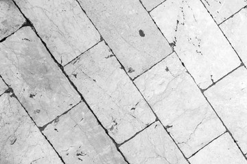 Close-up of a smooth paving at Stradun (or Placa), the main street in Dubrovnik, Croatia. Viewed from above in black and white.