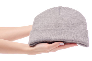 Warm hat gray in female hands. Sale and buy