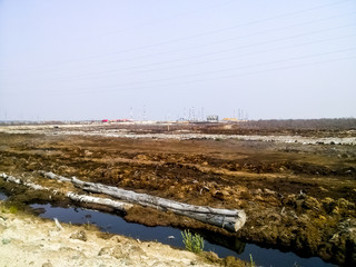 View of an industrial facility in western Siberia. Dirt and swamps.