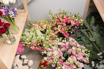 different varieties. Fresh spring flowers in refrigerator for flowers in flower shop. Bouquets on shelf, florist business.