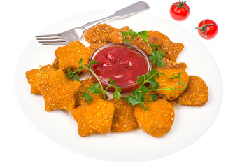 Nuggets of different shapes with ketchup on white background