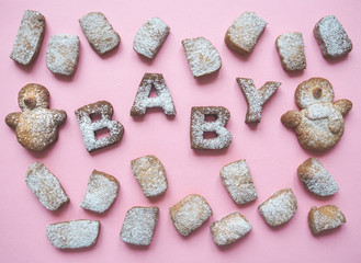 Fototapeta na wymiar The word Baby cookies on a pink background. The concept of the birth of his daughter. 