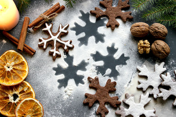 Christmas cookies in the shape of snowflakes posypanny flour and scattered on the table, spices. Food. Background closeup.