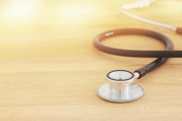 Image of stethoscope over wooden desk. Medical concept.