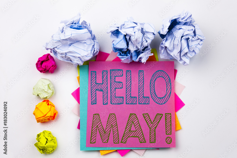Poster writing text showing hello may. spring written on sticky note in office with screw paper balls. busi