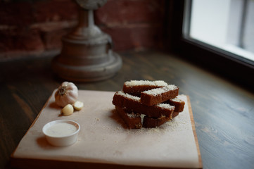 Garlic croutons on a on oiled paper. Photos atmospheric, rough, rustic style.