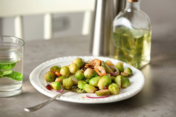 Plate with yummy brussel sprouts salad on table