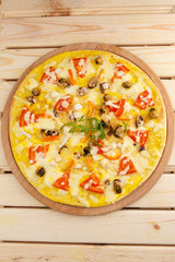 Pizza with seafood on wooden table