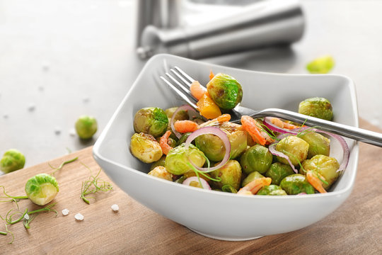 Dish with yummy brussel sprouts salad on table