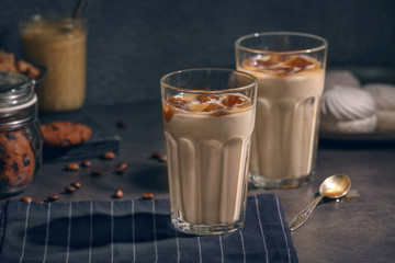 Glasses with delicious iced coffee on table