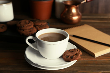 Ceramic cup with delicious coffee on wooden table