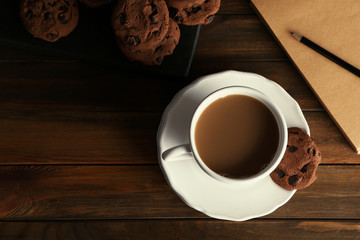 Ceramic cup with delicious coffee on wooden table