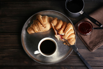 Metal tray with cup of delicious black coffee on table
