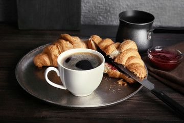 Metal tray with cup of delicious black coffee on table
