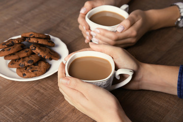Women having delicious coffee and biscuits for breakfast
