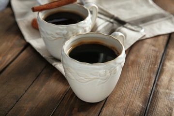 Ceramic cups with delicious coffee on table