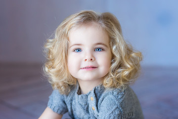 Beautiful toddler girl smiling. Сlose-up portrait. Blue eyes.