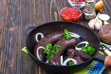 Hot blood sausage with onion on pan