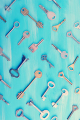 background from various keys on a blue wooden background