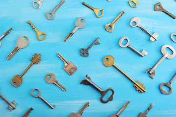 background from various keys on a blue wooden background