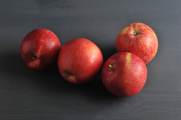 Fototapeta na wymiar red ripe apple on a dark rustic wooden background