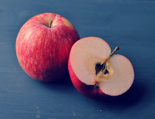 red ripe apple on a dark rustic wooden background