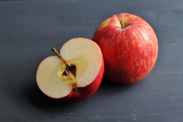 red ripe apple on a dark rustic wooden background