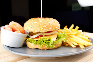 Burger with sauce and fries